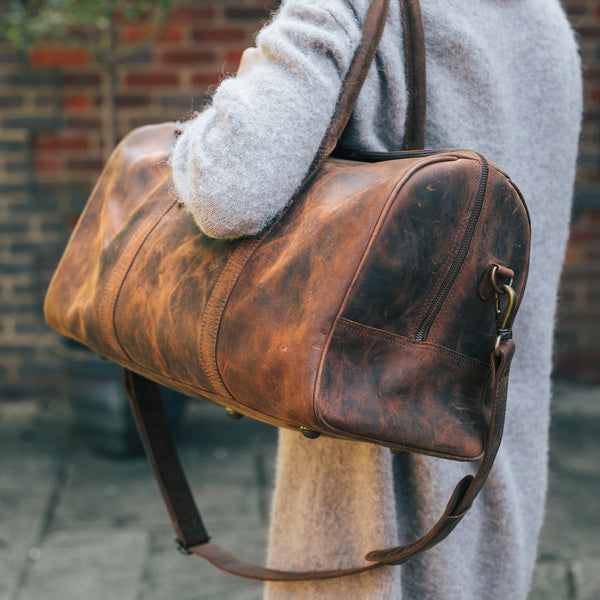 Woman holding a Leather Duffle Bag