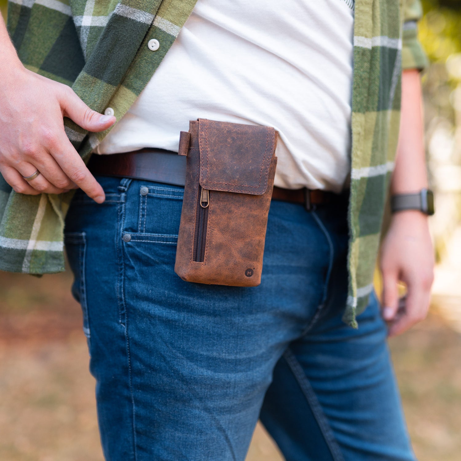 man wearing a brown leather phone holster on his belt