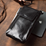 black leather phone holster placed on a desk