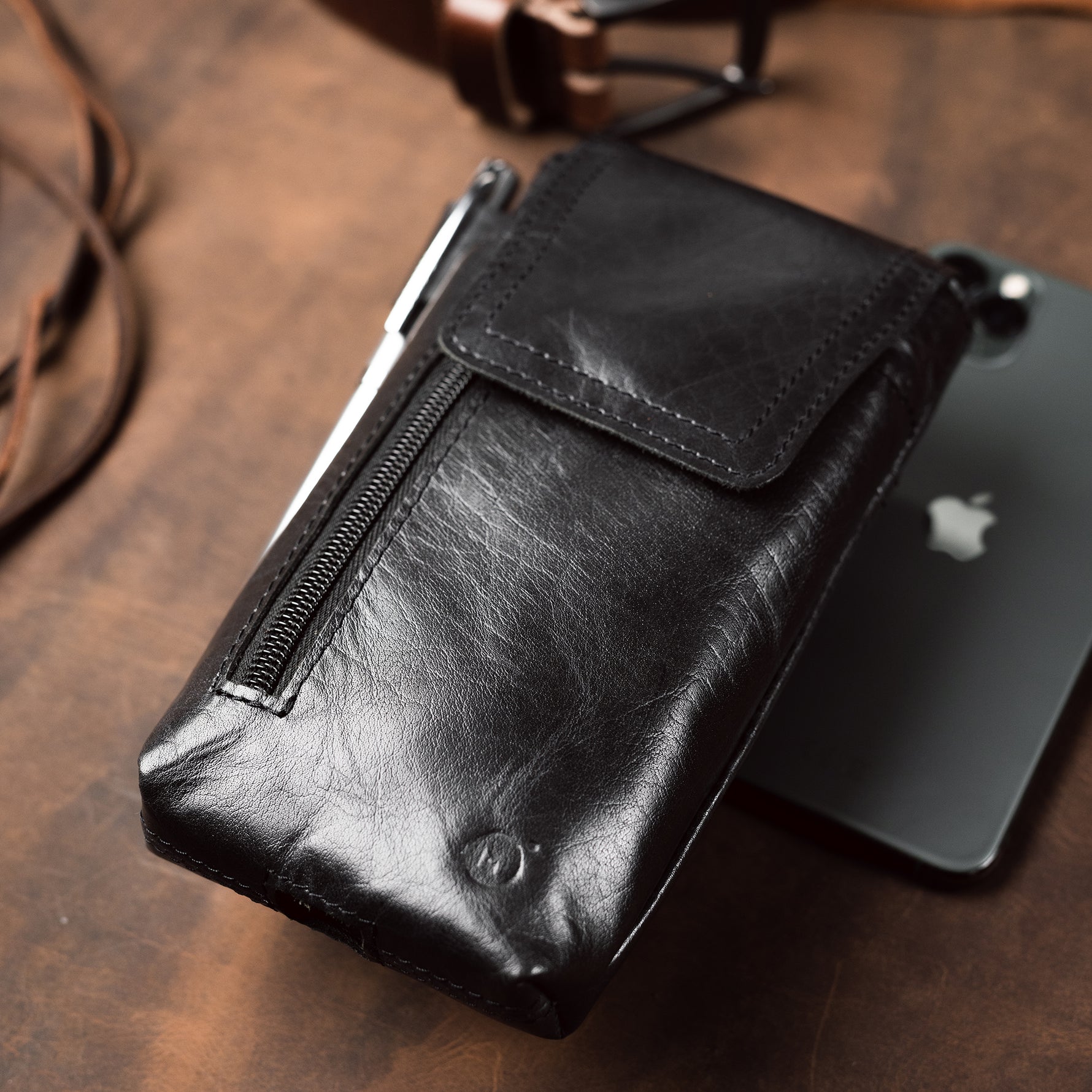 black leather phone holster placed on a desk
