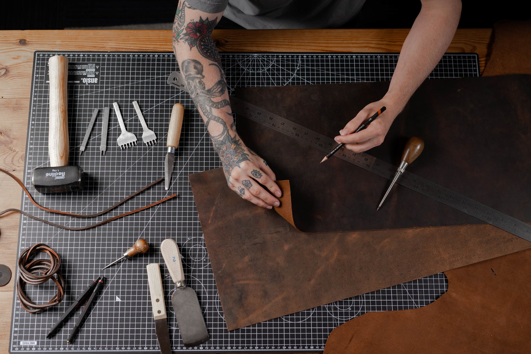 man measuring leather craft bundle to cut it