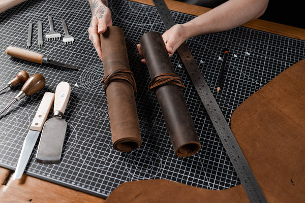 man holding a dark brown and soft brown leather craft bundles