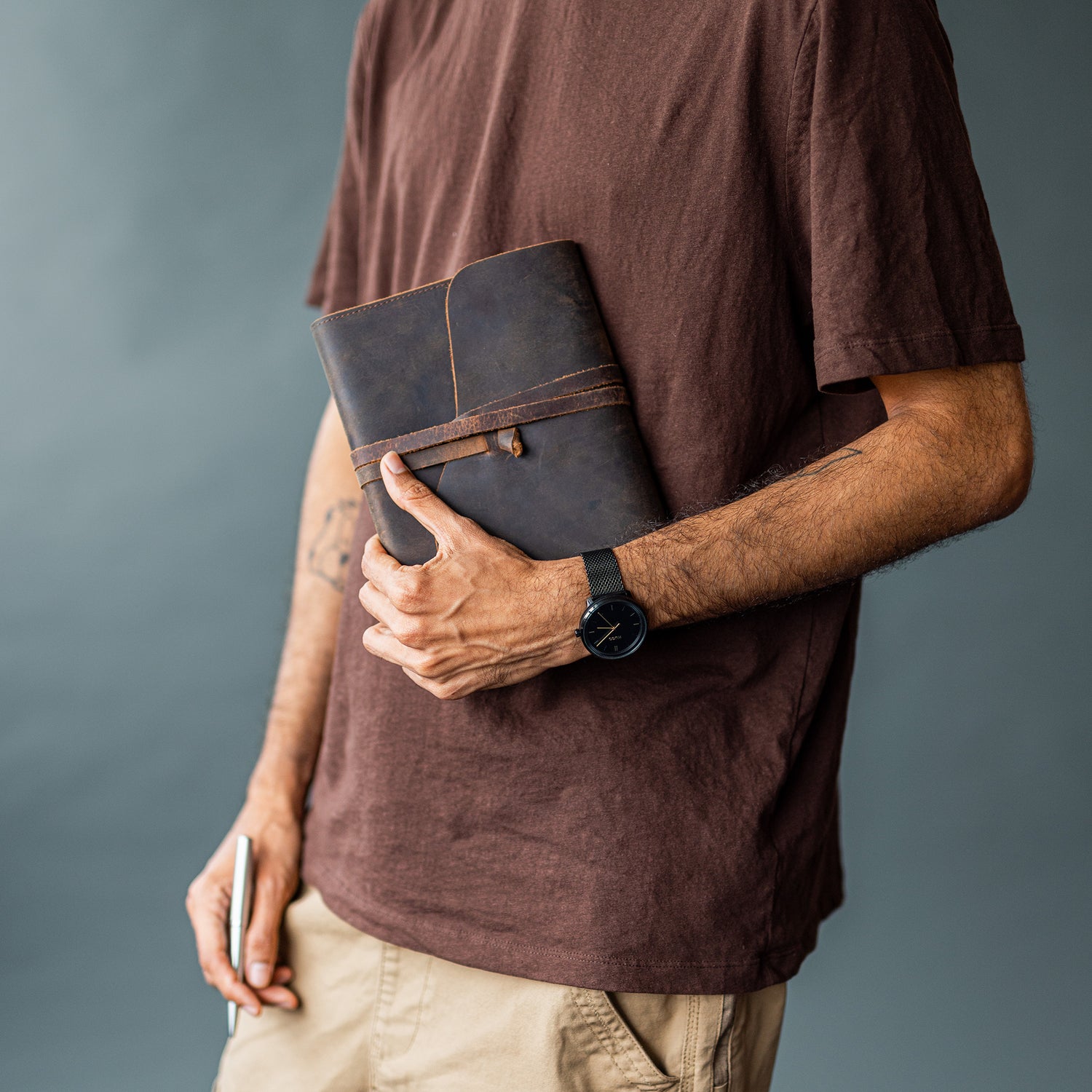 man holding a genuine leather journal