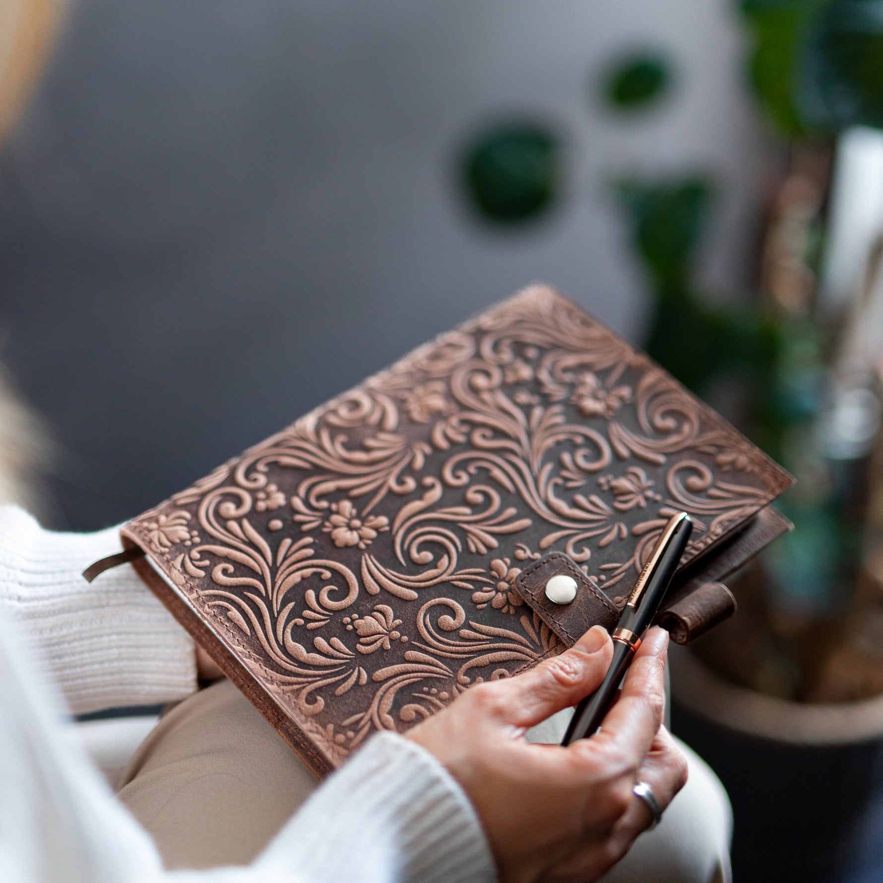 Woman holding the flower journal with a pen