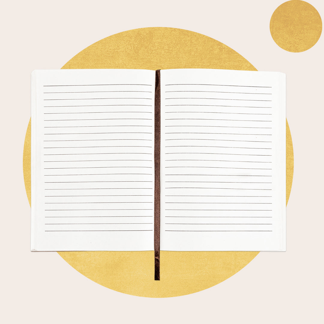 A lined cotton paper refill for a journal, with the paper fanned out to display the lined texture. There is a brown protective cover visible at the top.