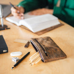 Dark brown leather pencil pouch placed on a desk