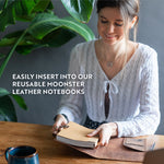 woman holding the milled lined paper refill