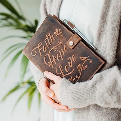 Woman holding a Faith Hope Love Journal