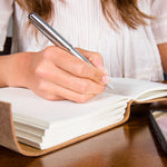 Woman writes in a Heart Journal 