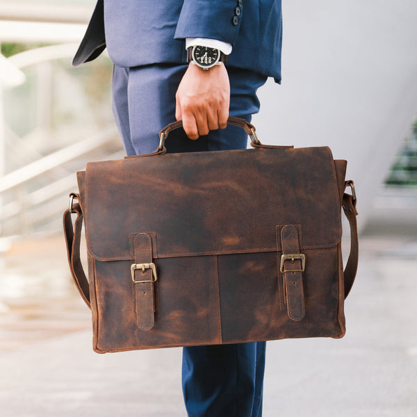 Business man holding a brown vintage Leather Messenger Bag